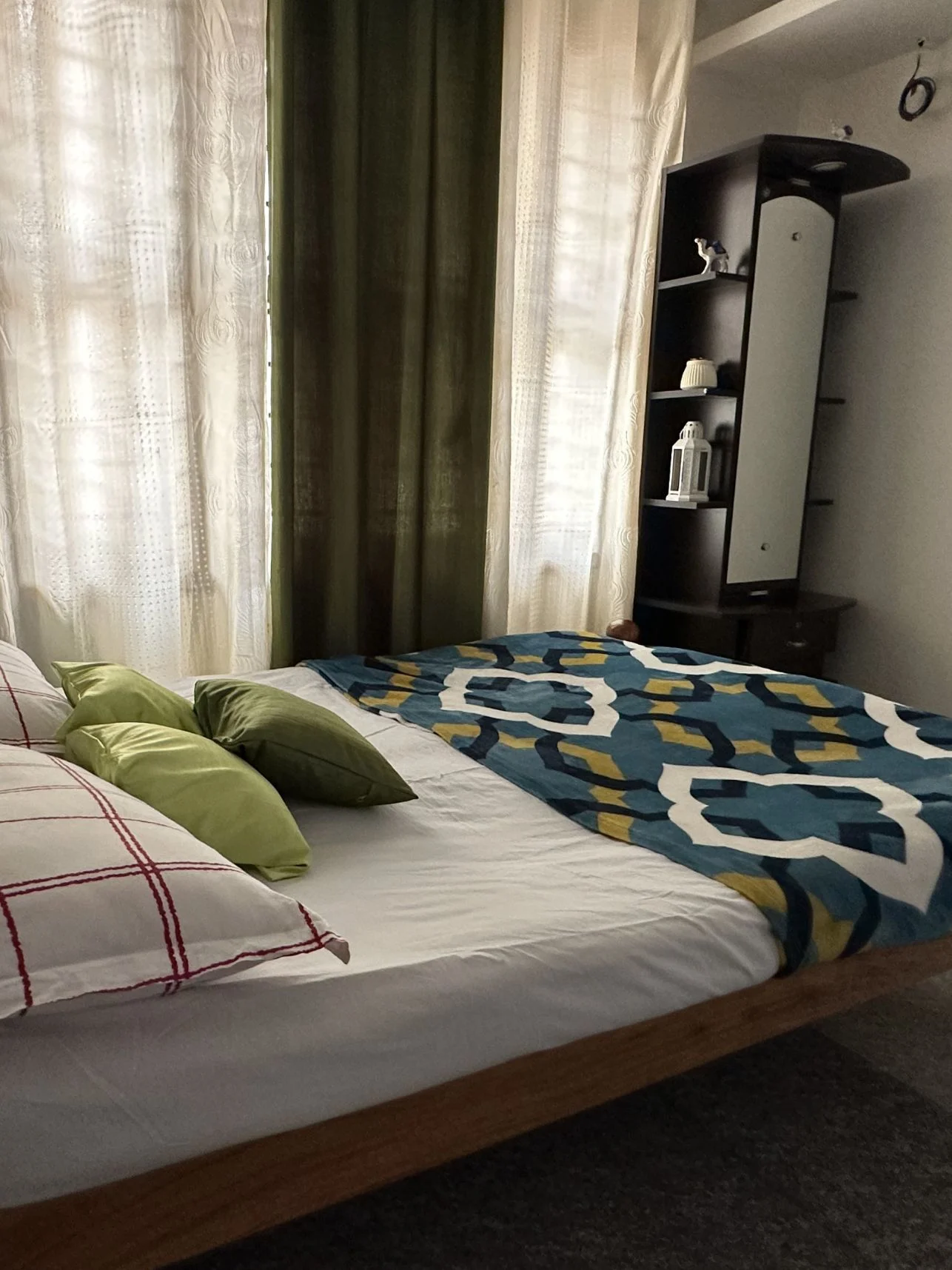 Private bedroom with patterned bedspread at Astagiri homestay.