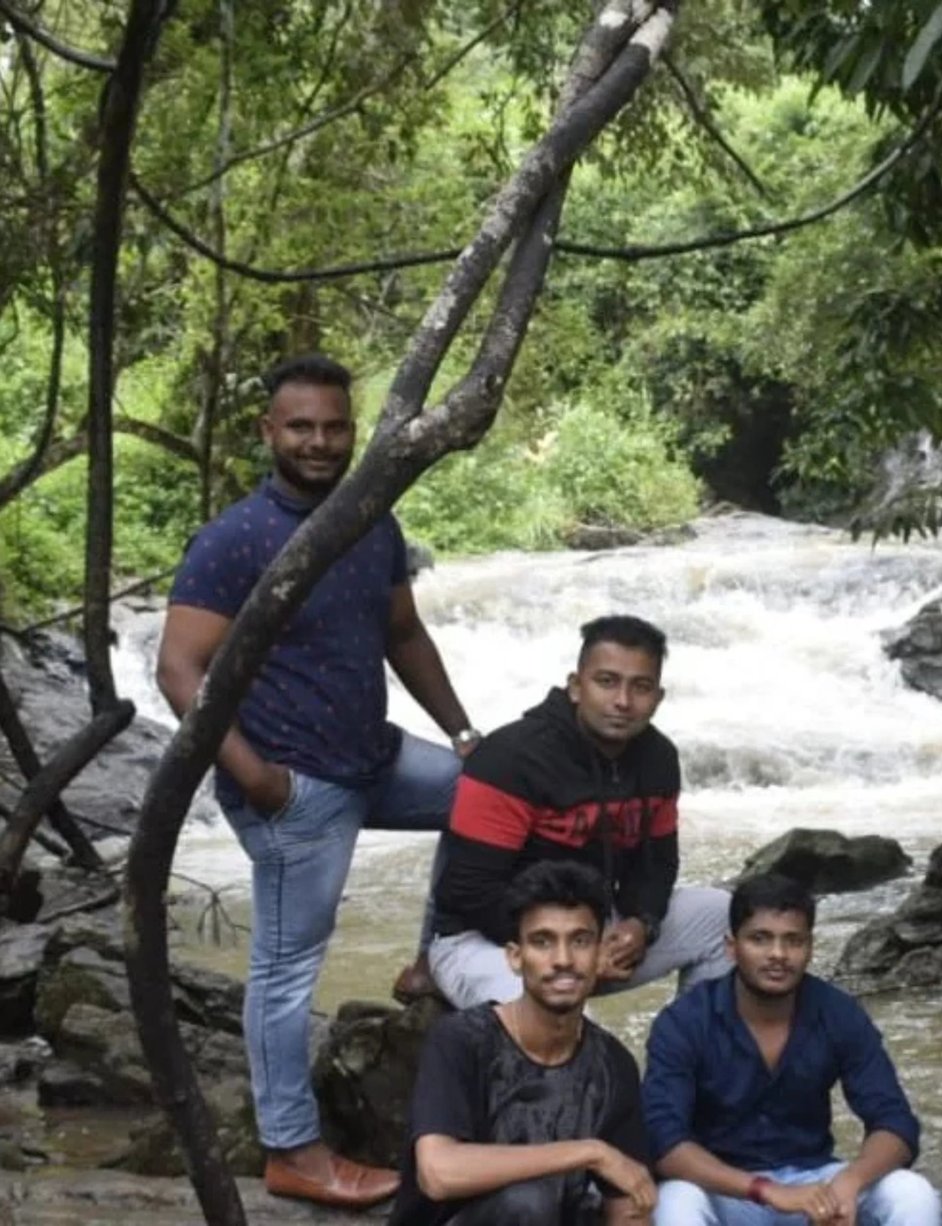 Guests enjoying a natural waterfall near the Chikmagalur homestay
