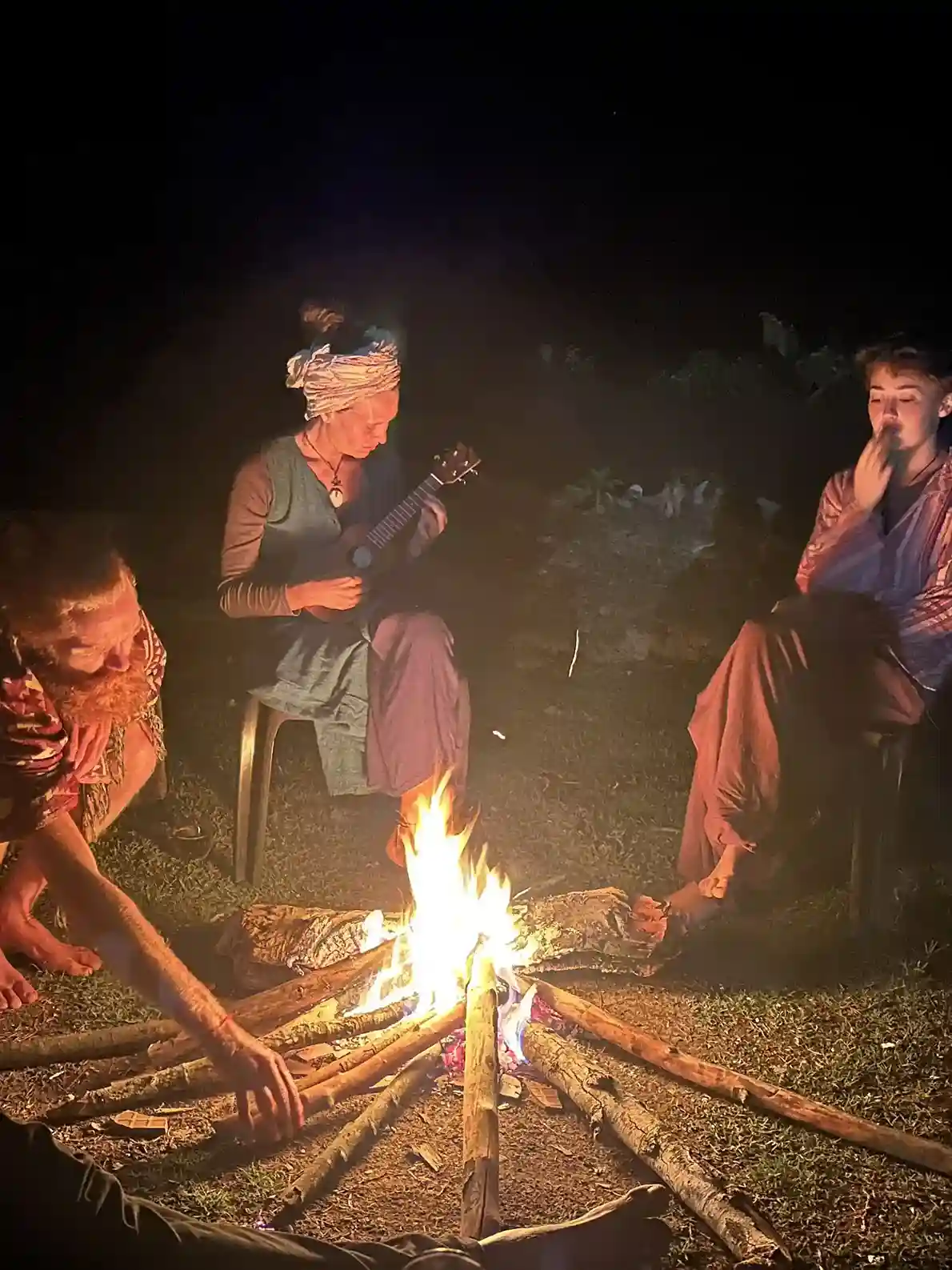 Guests gathered around a bonfire in the evening at Astagiri.