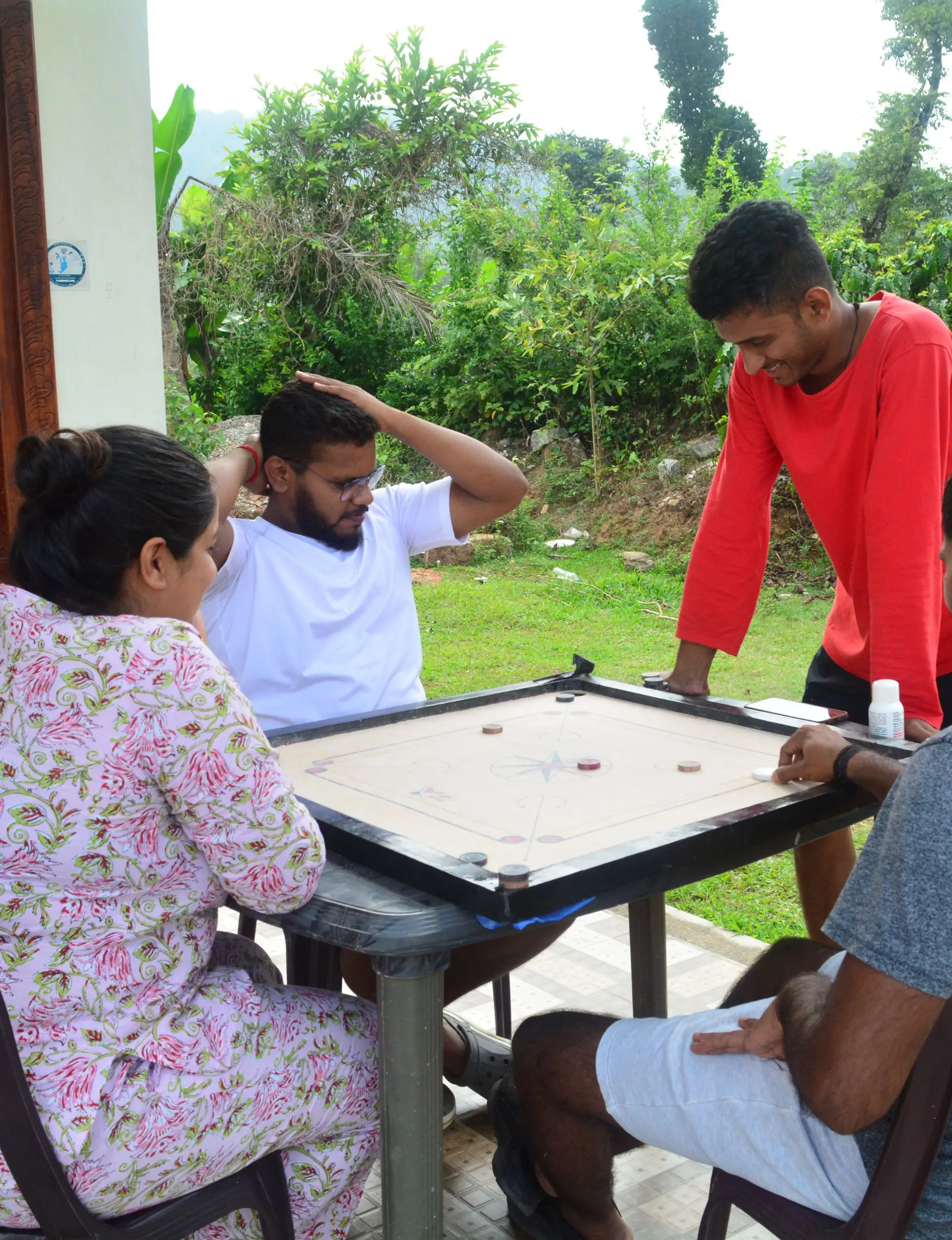 Travelers playing indoor games at a peaceful Chikmagalur homestay