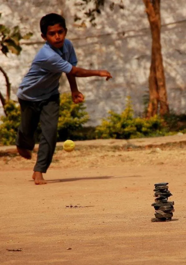 Boys playing lagori, a traditional Indian outdoor game.