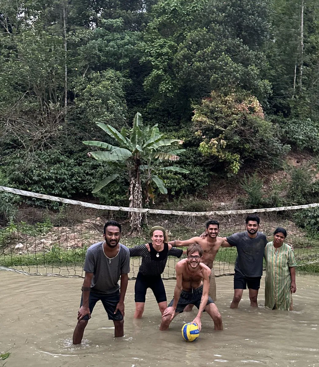Guests playing volleyball with the host family at Astagiri homestay.