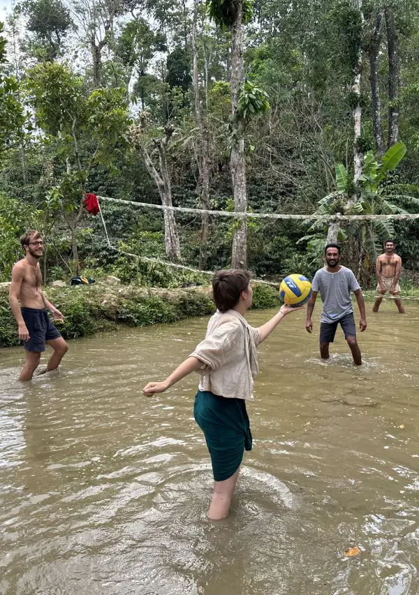 Guests playing mud volleyball, a fun activity at Astagiri homestay Chikmagalur.