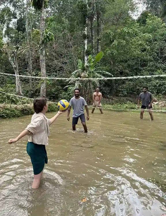 Guests playing mud volleyball at astagiri homestay